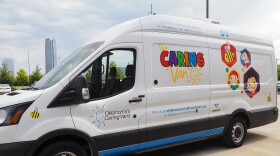 An Oklahoma Caring Foundation Caring Van sits outside the Latino Community Development Agency during a children’s vaccination clinic on July 9, 2026 in Oklahoma City.
