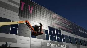 Workers install a sign in preparation for International CES at the Las Vegas Convention Center on Sunday, Jan. 4, 2015, in Las Vegas. CES is just one of the mega conventions that come to the city every year.