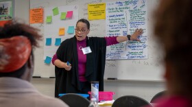 Jessica Perkins, a facilitator with Emerging Wisdom consultants, runs a discussion during St. Louis Public Schools' first community visioning session at Clyde C. Miller Career Academy on Saturday.