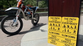 New signs on the Greenbelt will remind users to slow down and share the pathway. Some e-bikes, like the off-roading dirt bike pictured above, require permits and are not allowed on the Greenbelt.