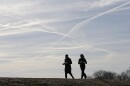 Contrails are seen behind joggers in 2014. in ohio.