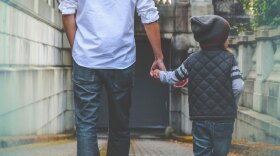 father and son holding hands