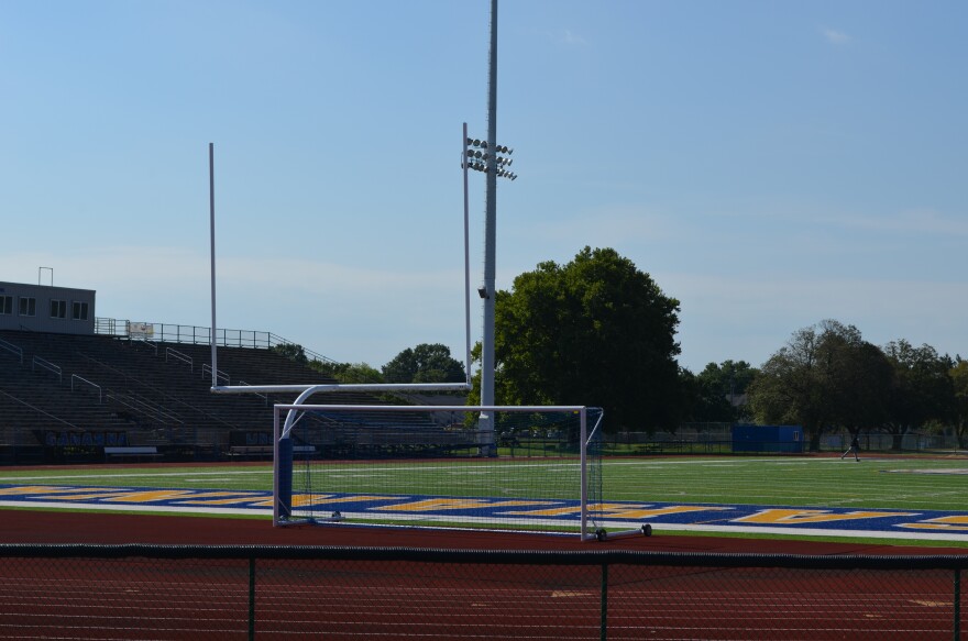 A goal post sits at the end of a football field.