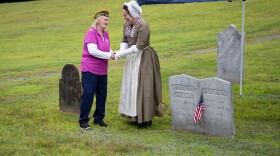 Doris Backus, left, of Sharon, Vt., shakes hands with Kristin Harris, Research Coordinator at the Boston Tea Party Ships & Museum, after placing a marker on the grave of Anthony Morse, a Boston Tea Party Participant, at Pine Hill Cemetery in Sharon, Vt., on Monday, Aug. 17, 2026. Backus, who is the cemetery's president and the fourth great granddaughter of Morse, helped to place the marker. "It meant a lot," Morse said of the experience. "I never thought I would've found something like this." (Valley News photo)