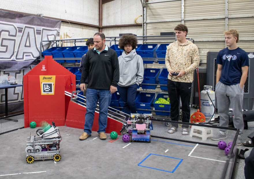 China Spring robotics coach Brendan Smith, center, observes one of his team's robots during a practice session Tuesday, March 17, 2026. The program, in its first year, is preparing for its first UIL state competition on Friday, March 20, 2026.