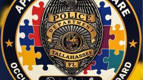 This TPD decal has a badge and the words "Approach with care. Occupant with autism on board."