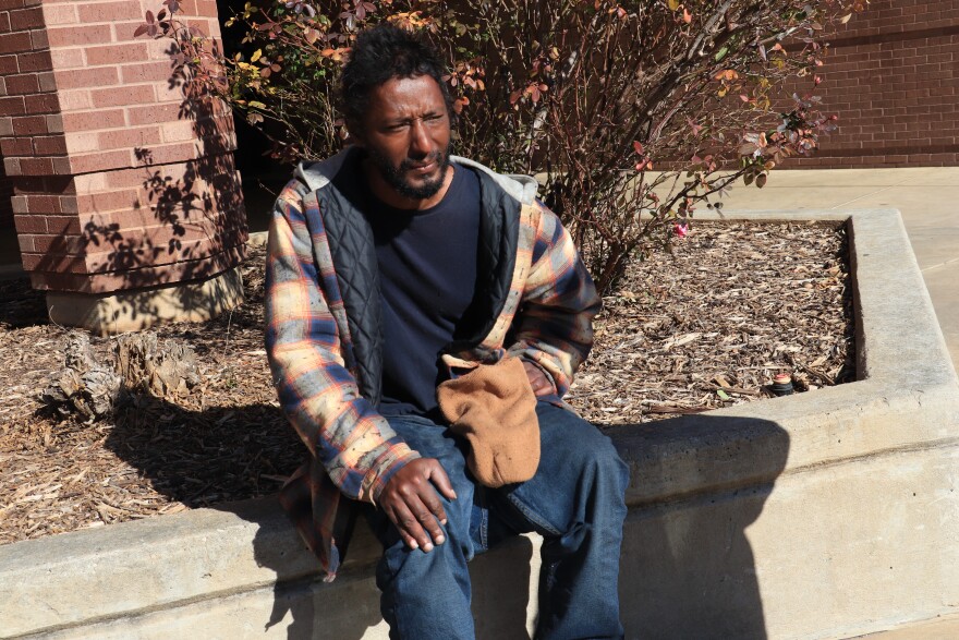  Shawnee resident Brandon Bryant sits outside the Shawnee Public Library. 