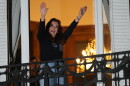 Former Argentine President Cristina Fernandez, who is serving a prison sentence under house arrest for corruption, waves from the balcony of her home during a rally marking the fourth anniversary of the assassination attempt against her in Buenos Aires, Argentina, Tuesday, Sept. 1, 2026.
