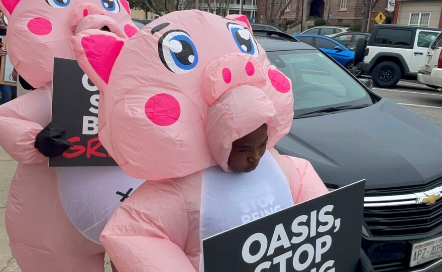 Demonstrators rally outside OASIS offices