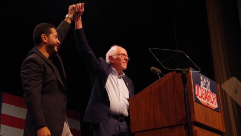 Bernie Sanders holds up the arm of Abdul El Sayed. 