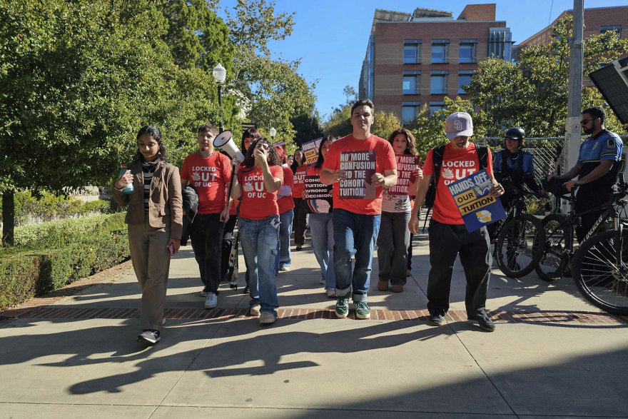 Dozens of UC students march outside a meeting of the University of California Board of Regents in Los Angeles to protest the system’s plan to continue annual tuition increases on Nov. 19, 2025.