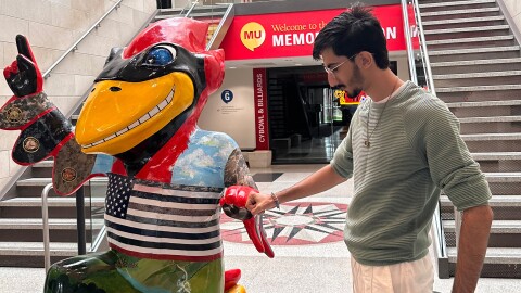 Daniyal Shahbaz, a native of Pakistan, stands next to the Iowa State University mascot inside the school’s Memorial Union building during fall freshman orientation in 2024.