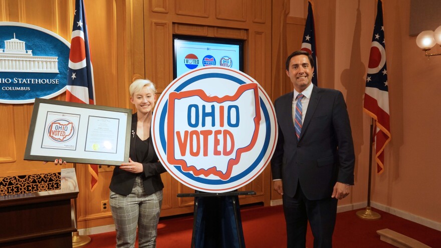 Emily Legg and Secretary of State Frank LaRose after unveiling her winning "I Voted" sticker design.