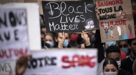 A demonstrator holds up a placard reading 'Black Lives Matter' in Toulouse, France, during a protest against police violence and in memory of late US citizen George Floyd as well as French citizen Adama Traore.
