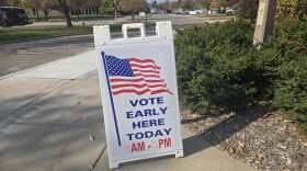 Vote Early Here Today sandwich board sign with an American flag design with a written time of 9 AM to 5 PM