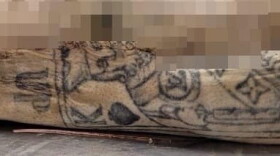 Tattoo of the King of Spades on the left arm of the victim.