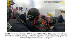 Federal authorities allege police bodycam footage shows Marine veteran Nathan Thornsberry pushing against a barricade during the breach of the U.S. Capitol on Jan. 6, 2021.