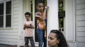 Catherine Manson sits on the front porch with her children, Caydence Manson and Carter Manson, in Hartford, Conn., on Wednesday, May 25, 2022. The prevalence of asthma in the Connecticut public school system has slightly decreased over time but 25,576 students have asthma, or about 1 in 8, including Caydence and Carter. But the incidence among Black students is about 50% higher. (AP Photo/Wong Maye-E)