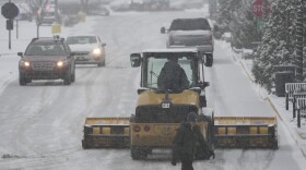 A plow clears a parking lot during a winter storm, Sunday, Jan. 5, 2025, in Cincinnati. (AP Photo/Joshua A. Bickel)