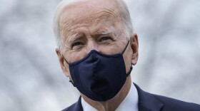 President Biden stops briefly to talk to the press as he walks toward Marine One on March 16.