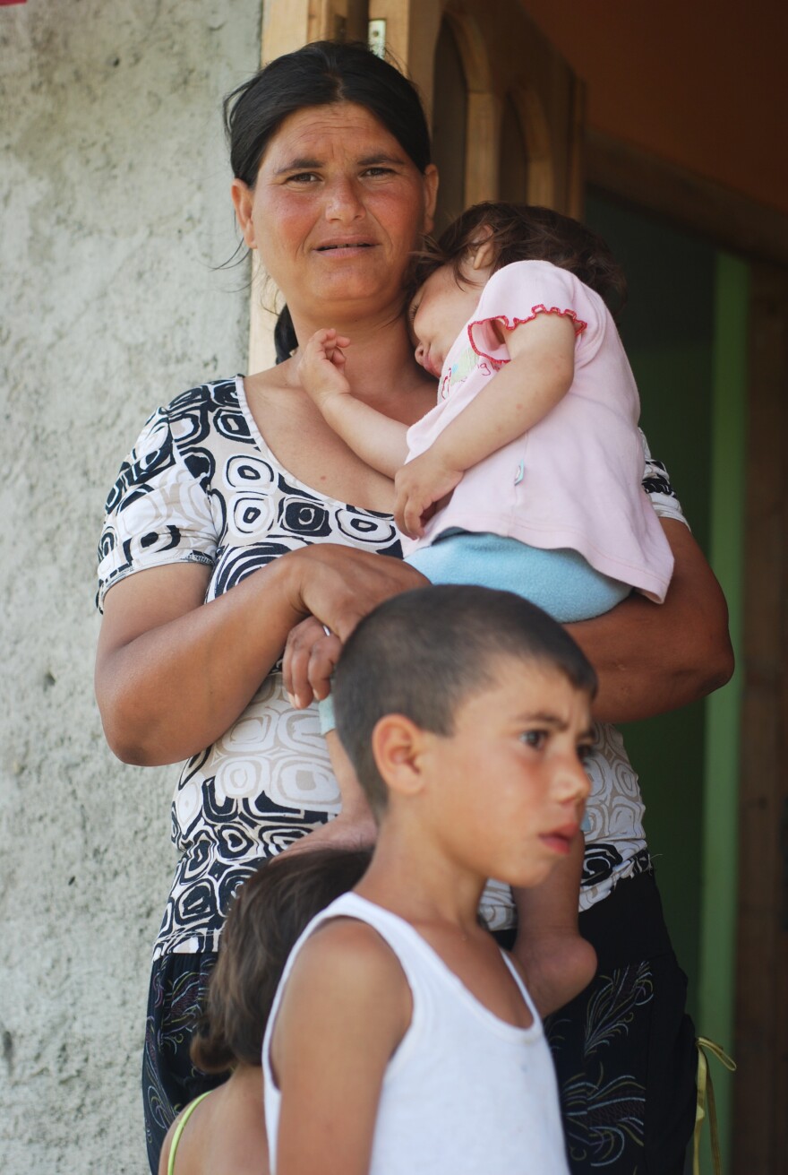 Mioara, 36, received materials to build a house in exchange for reintegrating two of her eight children back into the family.