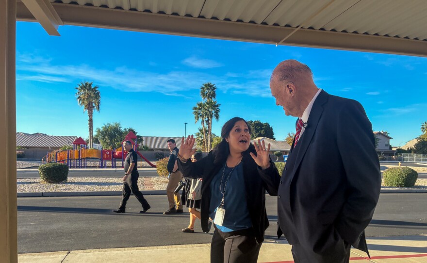 Principal Analisa Angulo animatedly shares the keys to Desert View Academy's success with Horne.