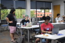 Paul Chin, left, helps Belinda Terry, center, with her code on HTML Day during an event hosted by 757 Tech on Aug. 8, 2026.