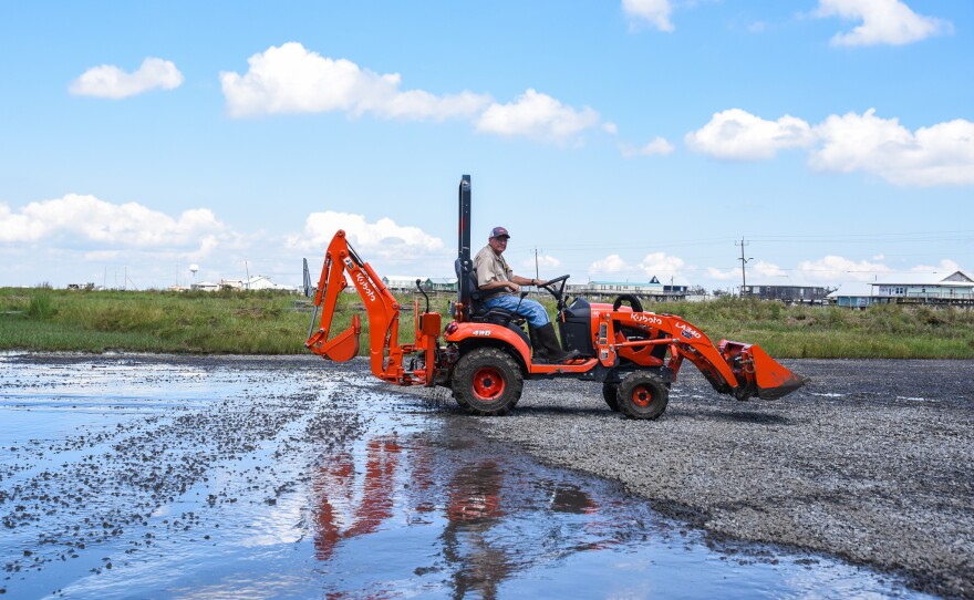 Louisiana Universities Marine Consortium staff scoop up mud left behind by Hurricane Francine, a Category 2 storm, on Friday, Sept. 13.