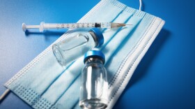 A mask, vaccine and a syringe