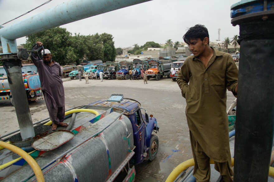 A water tanker driver fills his vehicle at a hydrant in Karachi.