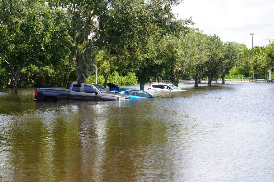 Cars almost nearly submerged in flood waters