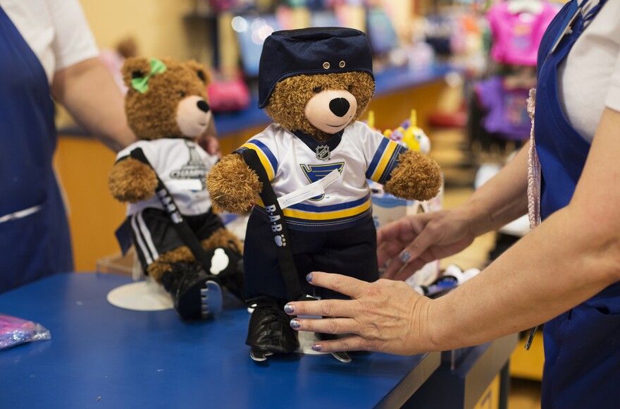 A Build-A-Bear employee sets out a display bear after dressing it in a new Blues uniform at at a store in the St. Louis Galleria. With the approval of a tax incentive package, the company is expected to move its headquarters to downtown St. Louis.