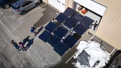 A deployed portable solar generator looks up at the sun outside of the PowerLabs workshop in Beverly.