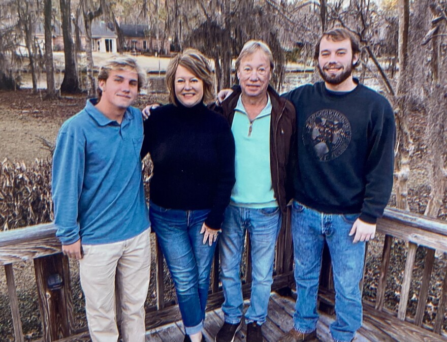 Drew (far right) with his parents and brother.