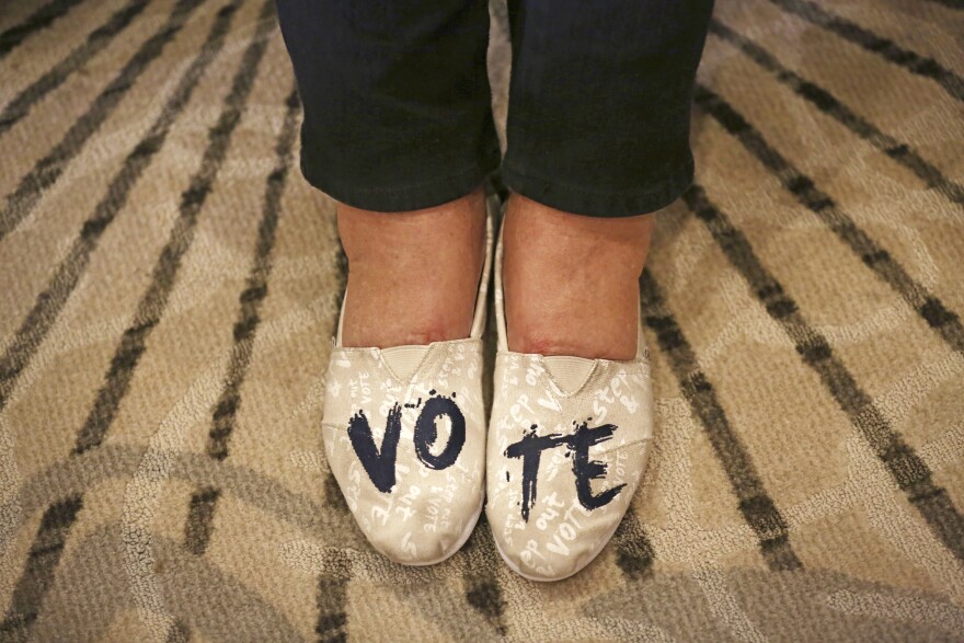 Anne Mullen, of Dallas, wears shoes with "VOTE" written on them during an election night party for Democratic candidate Colin Allred in Dallas, Tuesday, Nov. 6, 2018.
