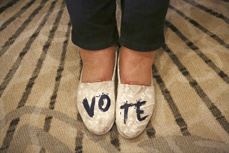 Anne Mullen, of Dallas, wears shoes with "VOTE" written on them during an election night party for Democratic candidate Colin Allred in Dallas, Tuesday, Nov. 6, 2018. 