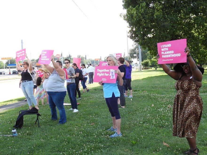 West Kentucky residents hold signs at a rally in Paducah's Noble Park in support of reproductive rights in the immediate wake of the Supreme Court decision to overturn Roe v. Wade.