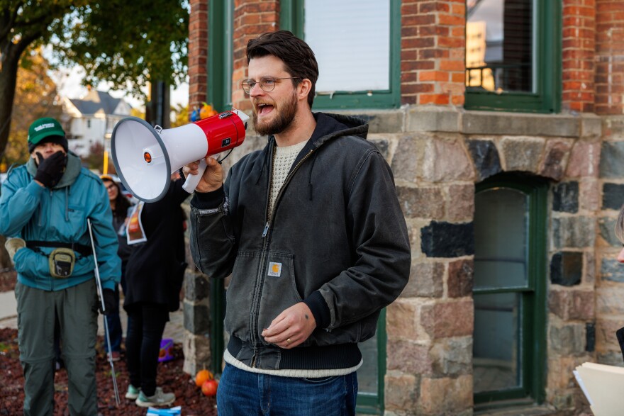 Democratic U.S. House candidate William Lawrence speaks at a protest outside U.S. Rep. Tom Barrett's office in Lansing, Mich., on Oct. 30, 2025.