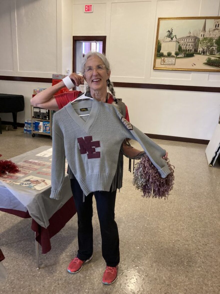 Oklahoma City woman Terry Fife poses with her sweater from Northeast High School shortly before a ceremony dedicating the plaza at Classen SAS High School at Northeast. Fife attended Northeast High School in the 1970s.