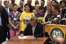 Gov. Ned Lamont signs the legislation gradually increasing Connecticut's minimum wage to $15, with continuing adjustments tied to inflation, May 28, 2019.