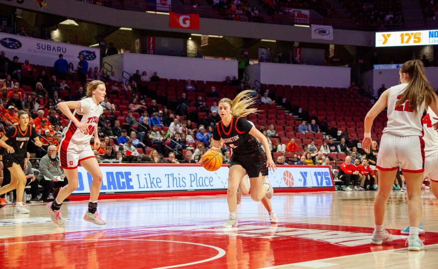 Girls high school basketball players inside an arena