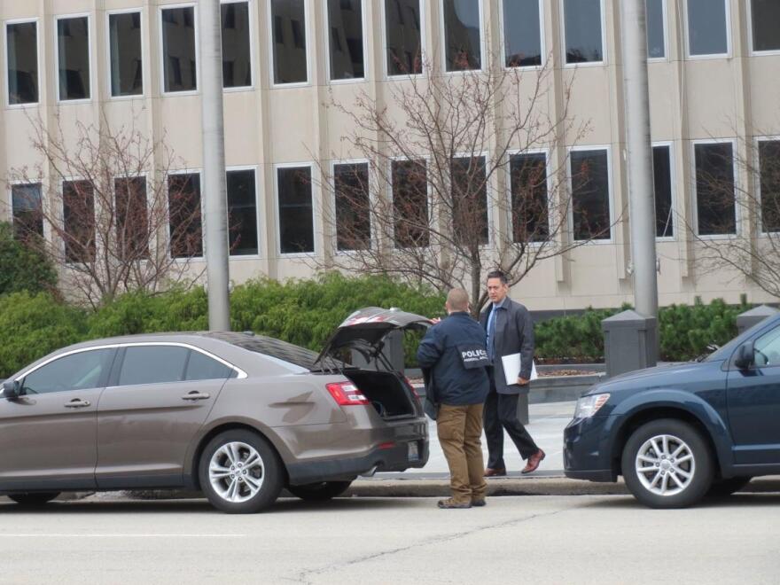 Federal agents load documents into a car taken from Caterpillar's then-world headquarters on Adams Street in downtown Peoria on March 2, 2017.