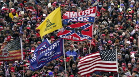 Supporters listen as former President Trump speaks as a Confederate-themed and other flags flutter in the wind during a rally in Washington on Jan. 6. (Evan Vucci/AP)