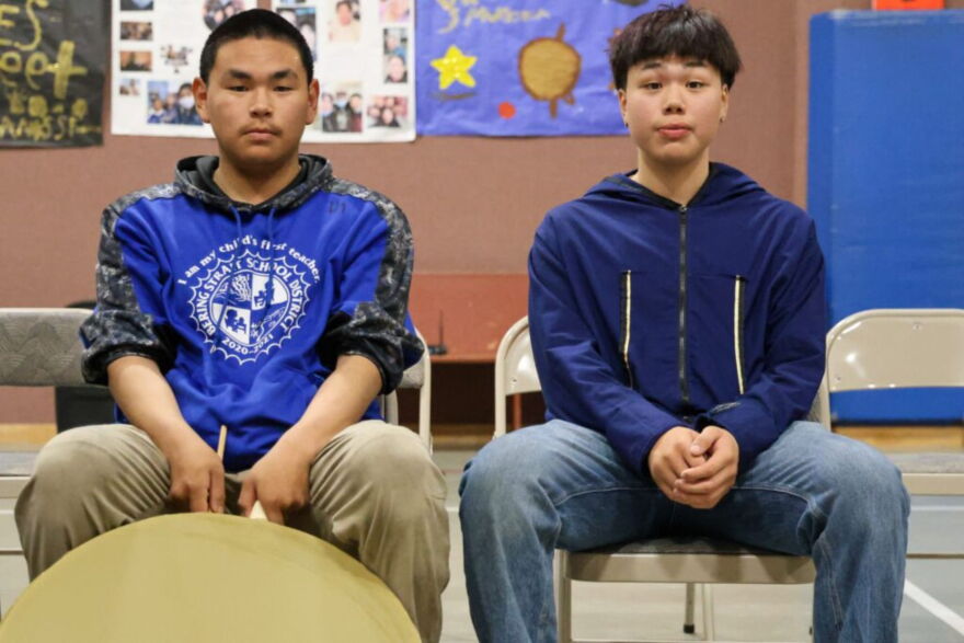 Cain Seetook (left) and Frank Komonaseak (right) sit in the Kingikmiut Dance Group drum line before performing at the 25th Annual Kingikmiut Dance Festival.