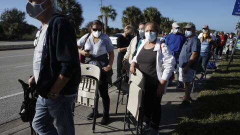 Seniors and first responders try to snag one of 800 doses available at a vaccination site in Fort Myers, Fla.