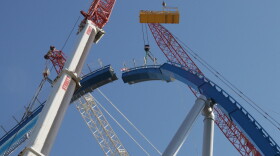 Lift Element #11, the lift hill's keystone, is lifted into place while the crew waits overhead to bolt both sides together.