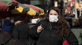 A woman in New York, who declined to give her name, says she works for a pharmaceutical company and told the AP photographer, "I'd wear a mask if I were you."