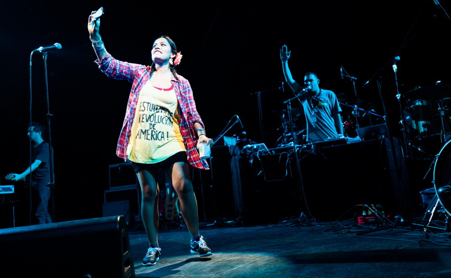 Tijoux took pictures of the crowd as it cheered. More than 7,000 people packed the Prospect Park Bandshell, while just as many were turned away outside.