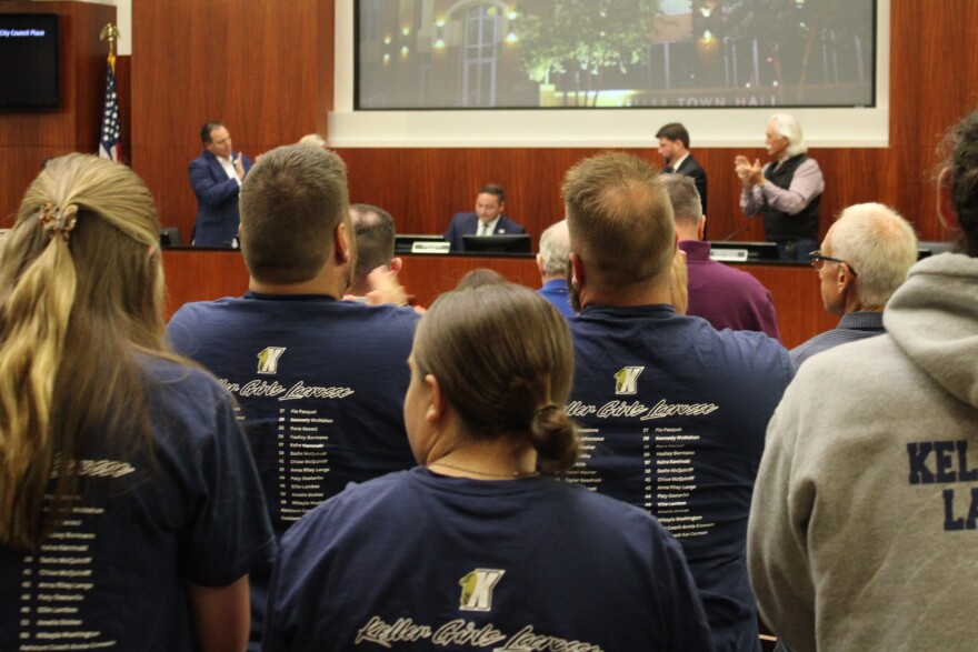 The crowd and city council offered outgoing Keller Mayor Armin Mizani, center, a standing ovation on his way out of office, May 19, 2026.