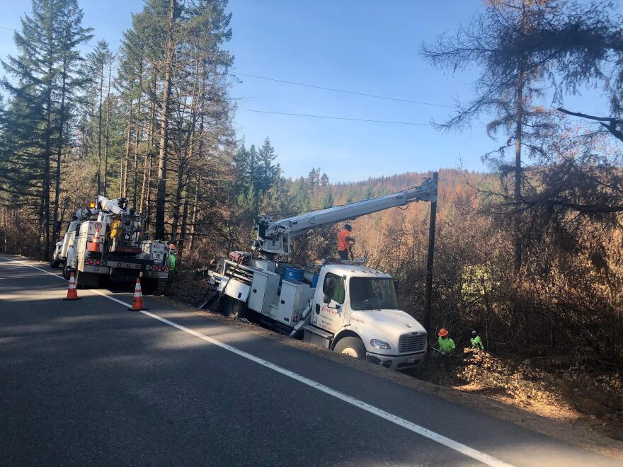 Utility crews replace power poles burned in the Beachie Creek Fire east of Salem in September 2020.